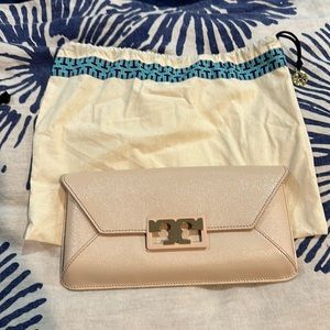 Cream Tory Burch magnetic closure clutch. Comes with dust cover bag.